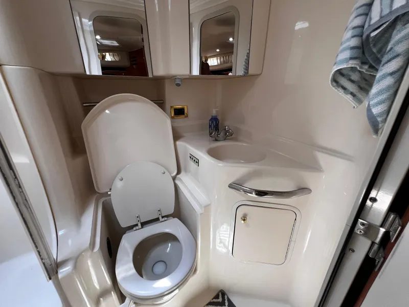 Slide: The Image of Bathroom of 2000 Sea Ray 380 Sundancer yacht with toilet, sink, and mirror. - 33