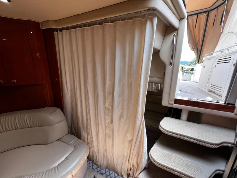 Slide: The Image of Interior of 2000 Sea Ray 380 Sundancer with curtain, seating, and steps to deck. - 35