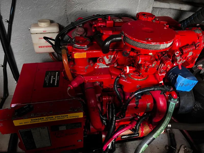 Slide: The Image of Engine compartment of a 2000 Sea Ray 380 Sundancer with red mechanical components. - 37
