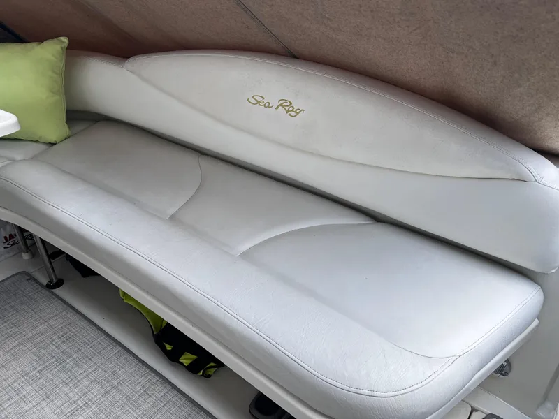 Slide: The Image of White leather seating on a 2000 Sea Ray 380 Sundancer boat interior. - 8