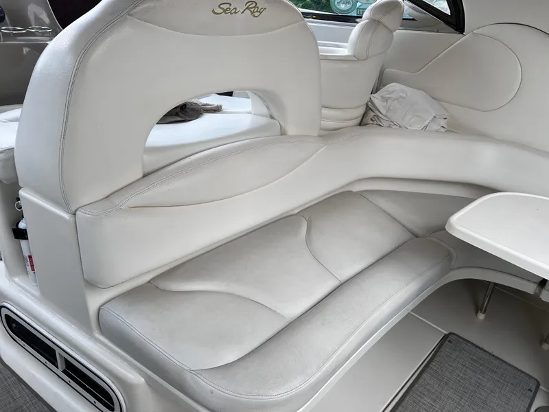 Slide: The Image of White leather seating on a 2000 Sea Ray 380 Sundancer boat interior. - 9