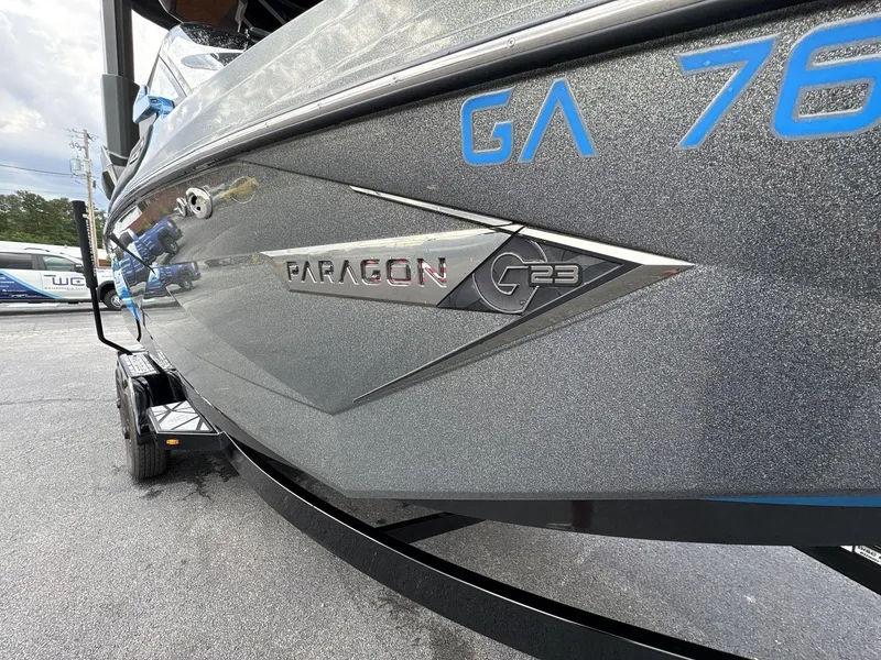 Slide: The Image of 2021 Nautique Super Air Nautique G23 Paragon boat side view with logo detail. - 11