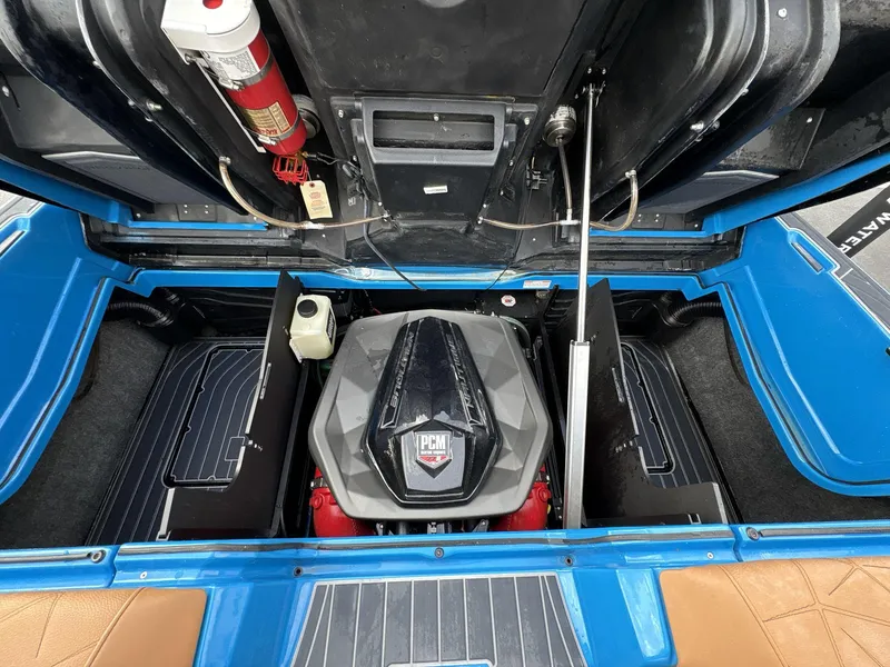 Slide: The Image of 2021 Nautique Super Air Nautique G23 Paragon engine compartment with PCM engine and fire extinguisher. - 12