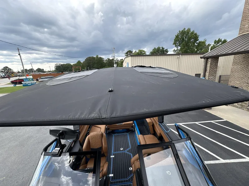 Slide: The Image of 2021 Nautique Super Air Nautique G23 Paragon with black canopy, parked outdoors. - 18