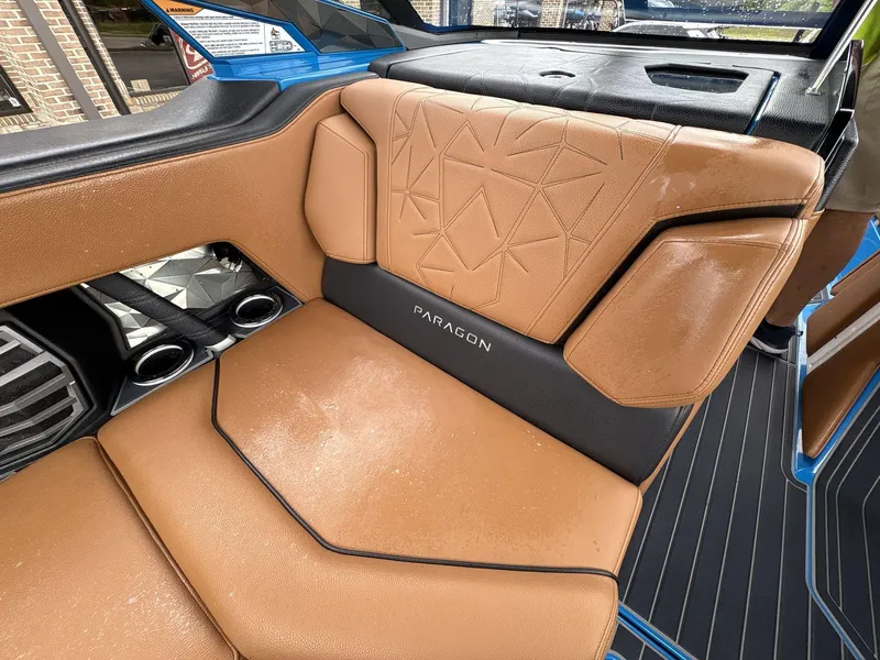 Slide: The Image of 2021 Nautique Super Air Nautique G23 Paragon interior with tan leather seating and "Paragon" branding. - 22