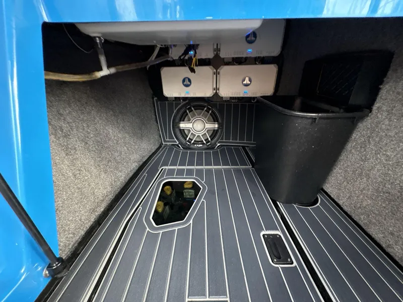 Slide: The Image of 2021 Nautique Super Air Nautique G23 Paragon interior with speaker and storage compartment. - 23