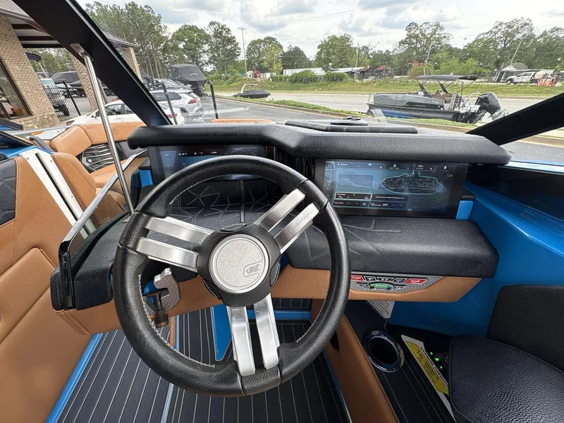 Slide: The Image of 2021 Nautique Super Air Nautique G23 Paragon dashboard with steering wheel and touchscreen display. - 27