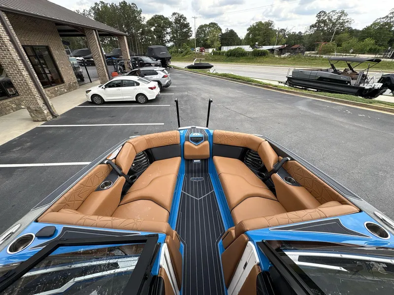 Slide: The Image of 2021 Nautique Super Air Nautique G23 Paragon boat interior with tan seating and blue accents. - 29