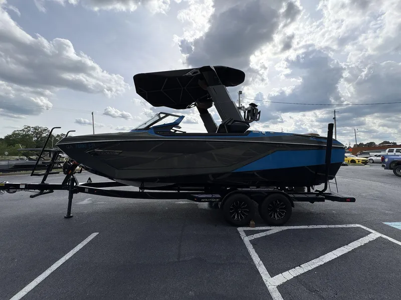 Slide: The Image of 2021 Nautique Super Air Nautique G23 Paragon boat on trailer under cloudy sky. - 3