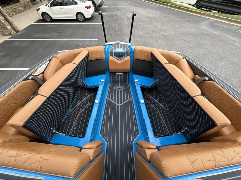 Slide: The Image of 2021 Nautique Super Air Nautique G23 Paragon interior with tan seating and blue accents. - 31