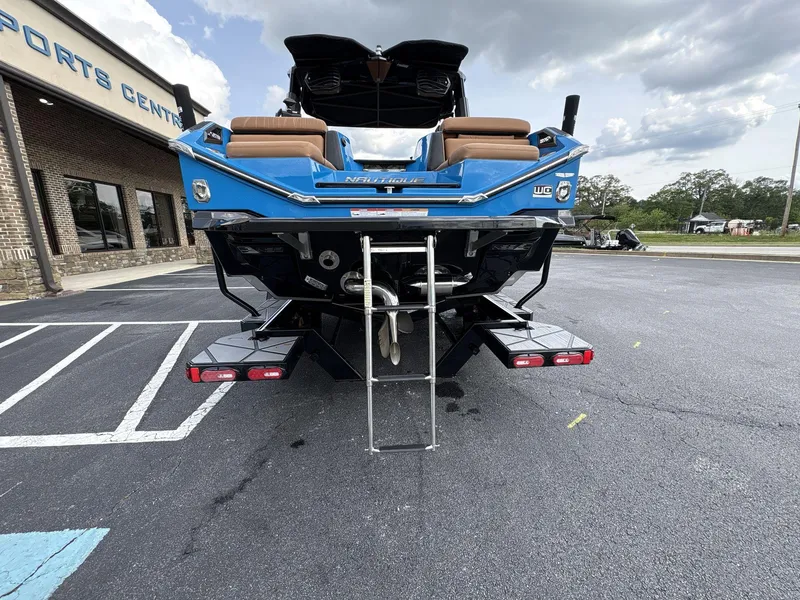 Slide: The Image of 2021 Nautique Super Air Nautique G23 Paragon boat, rear view, parked at sports center. - 5