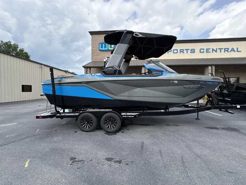 Slide: The Image of 2021 Nautique Super Air Nautique G23 Paragon boat on trailer, parked outside dealership. - 9