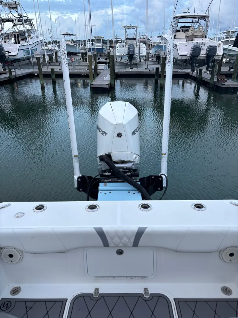 Slide: The Image of Canyon Bay 24H boat with Mercury engine docked at marina, 2020 model. - 10