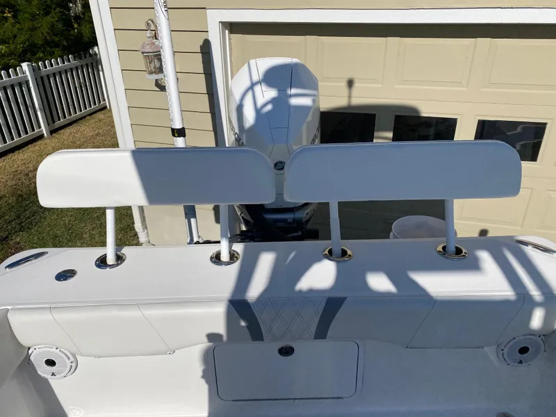 Slide: The Image of 2020 Canyon Bay 24H boat with dual seats and outboard motor in a driveway. - 11