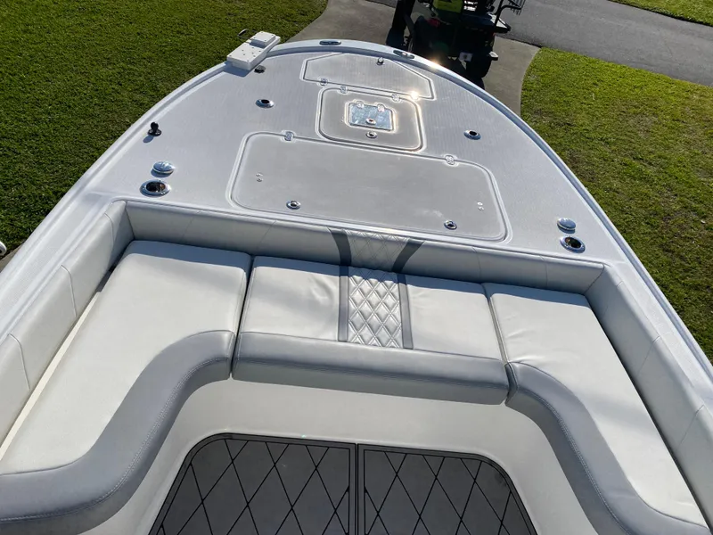 Slide: The Image of 2020 Canyon Bay 24H boat with cushioned seating and storage compartments. - 12