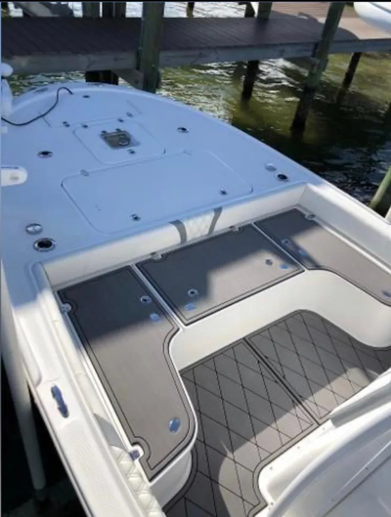 Slide: The Image of 2020 Canyon Bay 24H boat deck with storage compartments and non-slip flooring. - 13