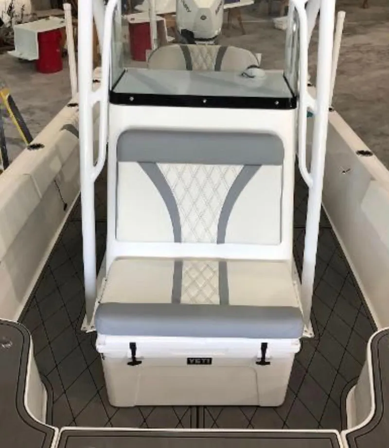 Slide: The Image of 2020 Canyon Bay 24H boat interior with cushioned seating and Yeti cooler. - 14