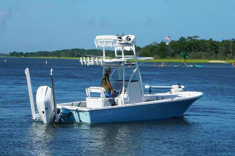 Slide: The Image of 2020 Canyon Bay 24H boat on a calm lake with a clear blue sky. - 21