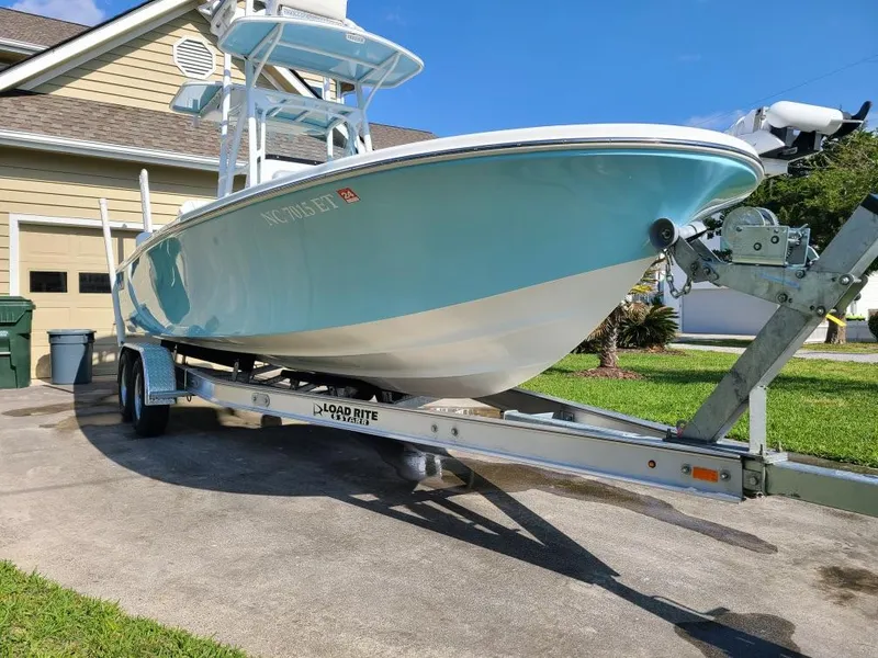 Slide: The Image of 2020 Canyon Bay 24H boat on trailer in driveway, sunny day. - 23