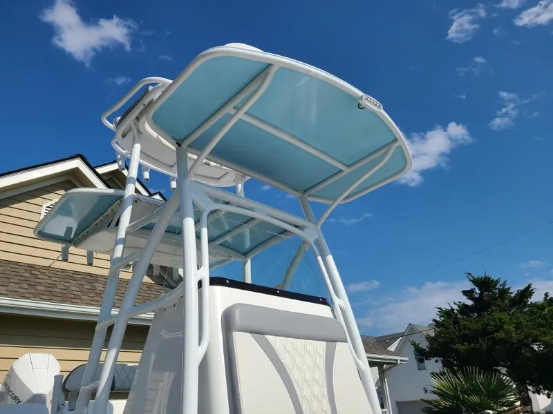 Slide: The Image of 2020 Canyon Bay 24H boat with elevated tower against a clear blue sky. - 25