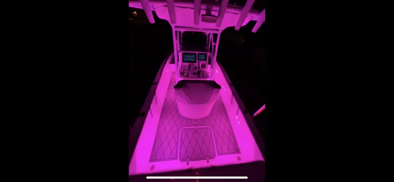 Slide: The Image of 2020 Canyon Bay 24H boat interior with vibrant pink LED lighting. - 26
