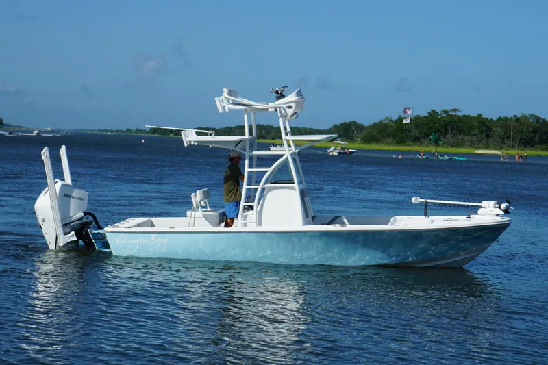 Slide: The Image of 2020 Canyon Bay 24H boat on water, featuring a sleek design and Mercury engine. - 3