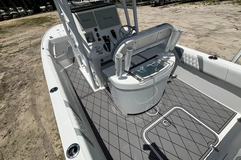 Slide: The Image of 2020 Canyon Bay 24H boat interior with modern console and seating, docked on sandy terrain. - 31