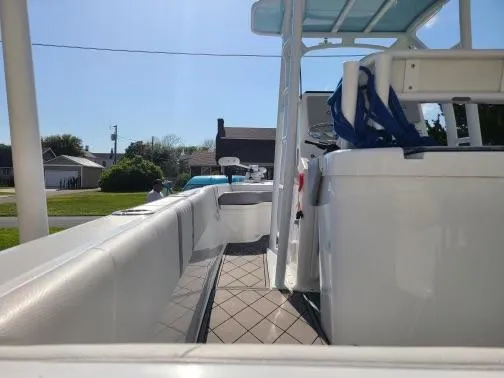 Slide: The Image of 2020 Canyon Bay 24H boat interior with seating and console, parked in a residential area. - 6