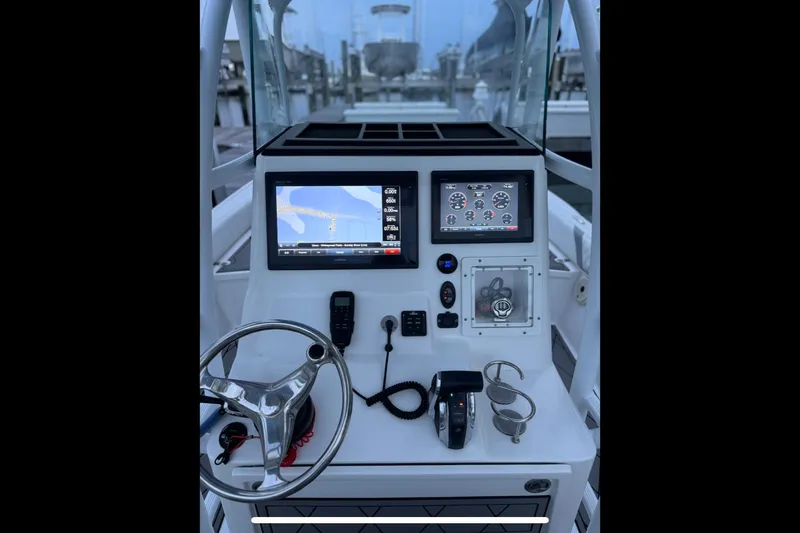 Slide: The Image of Canyon Bay 24H 2020 boat dashboard with navigation screens and controls. - 7