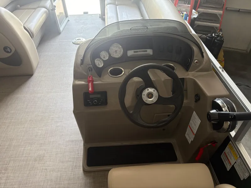 Slide: The Image of 2023 Sun Tracker PB 18 DLX boat console with steering wheel and gauges. - 4