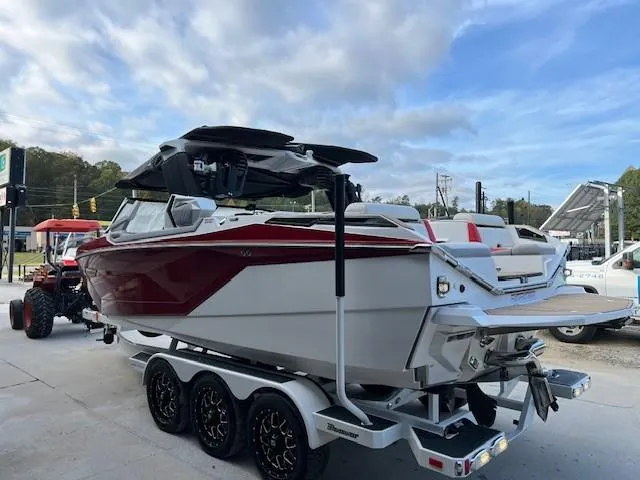 Slide: The Image of 2021 Nautique Super Air Nautique G23 Paragon boat on trailer, under cloudy sky. - 2