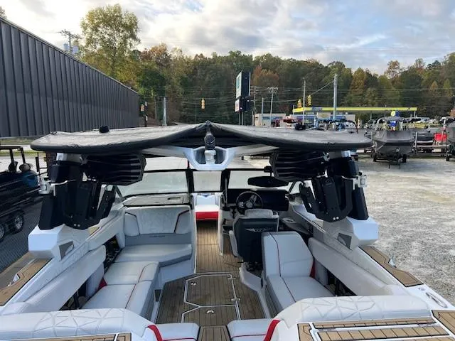 Slide: The Image of 2021 Nautique Super Air Nautique G23 Paragon interior with seating and speakers, parked outdoors. - 6