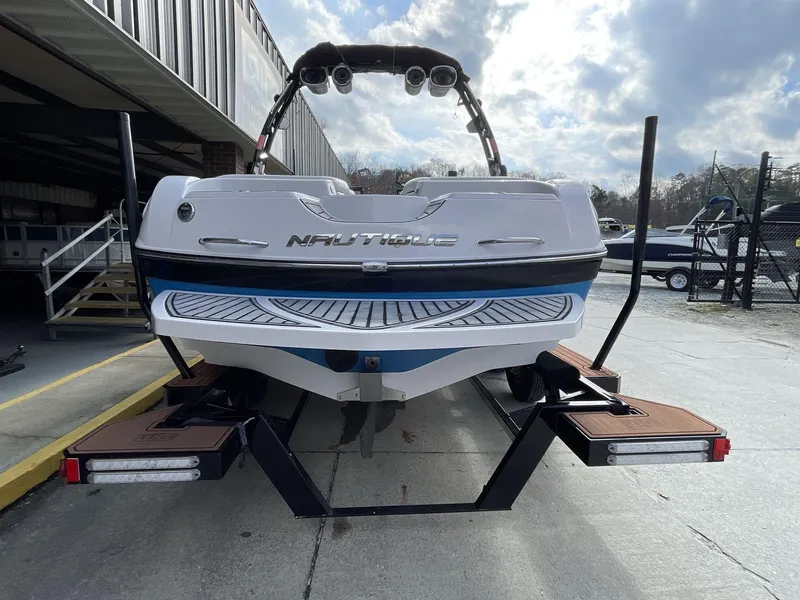 Slide: The Image of 2011 Nautique Super Air Nautique 230 boat on trailer, rear view, outdoor setting. - 12