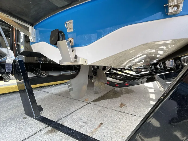 Slide: The Image of 2011 Nautique Super Air Nautique 230 boat underside with propeller and trailer. - 13