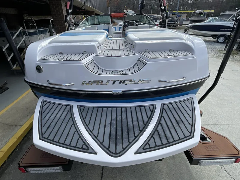 Slide: The Image of 2011 Nautique Super Air Nautique 230 boat, rear view, showcasing deck and branding. - 18