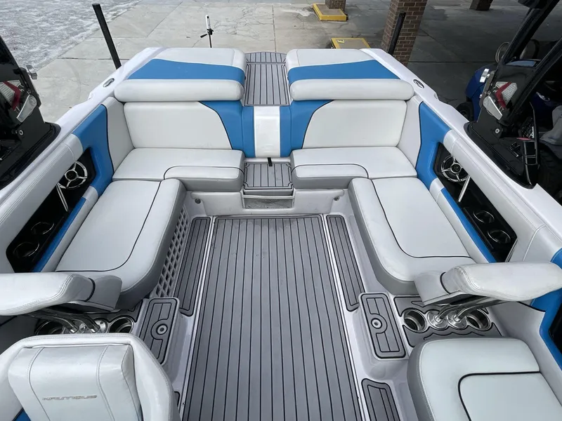 Slide: The Image of 2011 Nautique Super Air Nautique 230 interior with blue and white seating. - 23