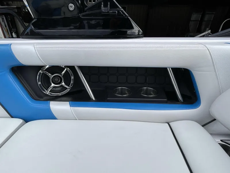 Slide: The Image of 2011 Nautique Super Air Nautique 230 interior with speaker and cup holders. - 24