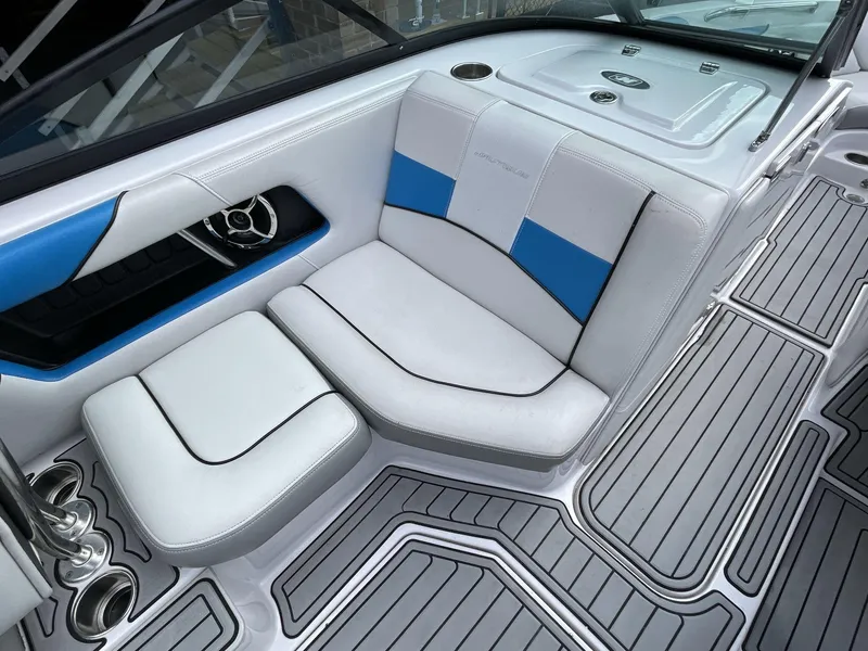 Slide: The Image of Interior of 2011 Nautique Super Air Nautique 230 boat with white and blue seating. - 25