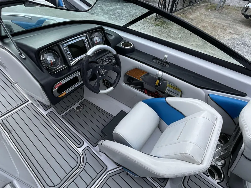 Slide: The Image of 2011 Nautique Super Air Nautique 230 cockpit with modern dashboard and steering wheel. - 26