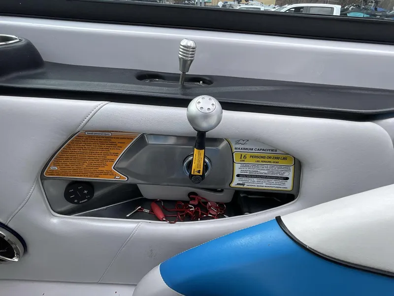 Slide: The Image of Interior of 2011 Nautique Super Air Nautique 230 boat, featuring control panel and capacity label. - 27