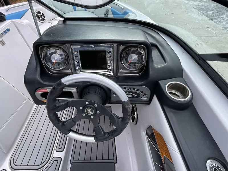 Slide: The Image of 2011 Nautique Super Air Nautique 230 dashboard with steering wheel and controls. - 28