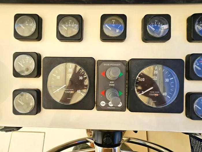 Slide: The Image of Dashboard of a 2001 Carolina Classic Express 35 boat with various gauges and controls. - 14