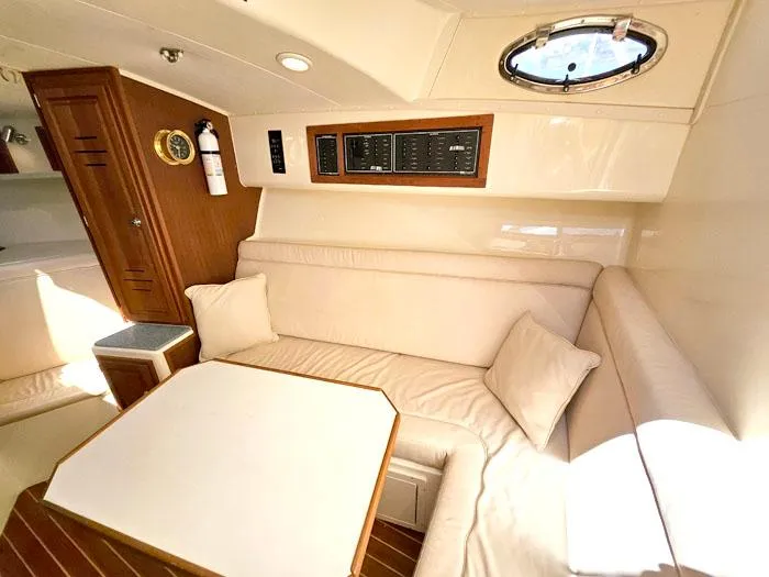 Slide: The Image of Interior of 2001 Carolina Classic Express 35 with beige seating and wooden accents. - 19