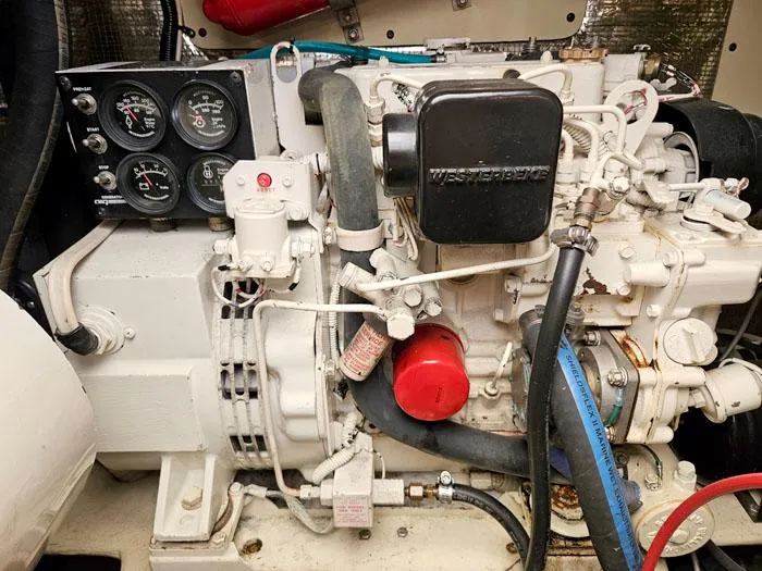 Slide: The Image of Engine compartment of a 2001 Carolina Classic Express 35 boat, featuring gauges and hoses. - 24