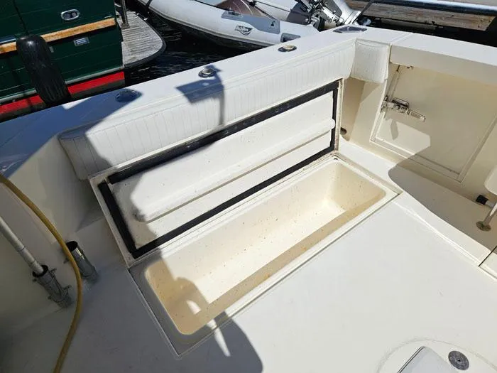 Slide: The Image of 2001 Carolina Classic Express 35 boat deck with storage compartment open. - 7
