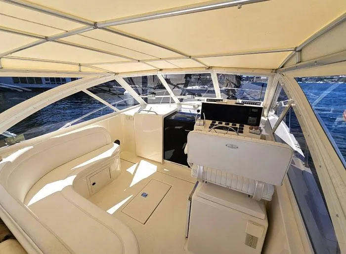 Slide: The Image of 2001 Carolina Classic Express 35 boat interior with helm, seating, and canopy. - 8