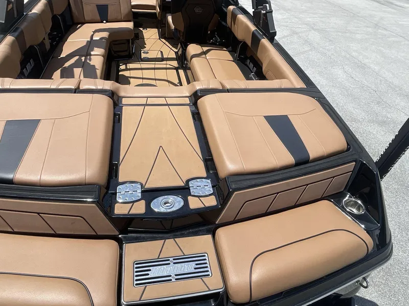 Slide: The Image of 2022 Malibu Wakesetter 23 LSV interior with tan and black seating, showcasing luxury design. - 13