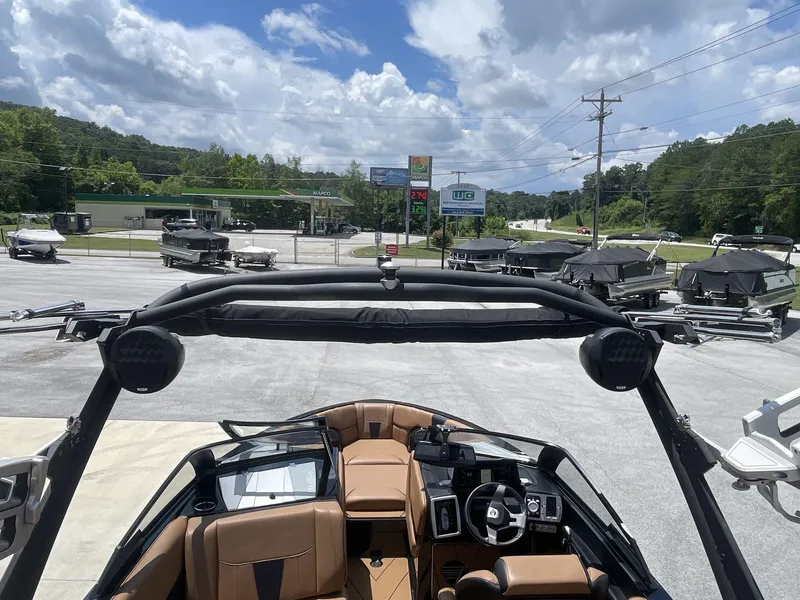 Slide: The Image of 2022 Malibu Wakesetter 23 LSV boat interior with dashboard and seating, parked outdoors. - 18