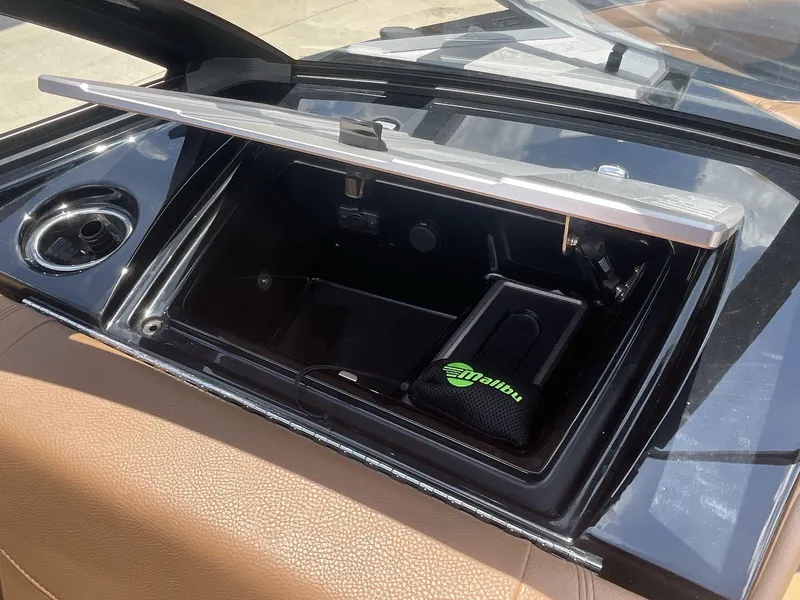 Slide: The Image of 2022 Malibu Wakesetter 23 LSV storage compartment with cup holder and branded pouch. - 19