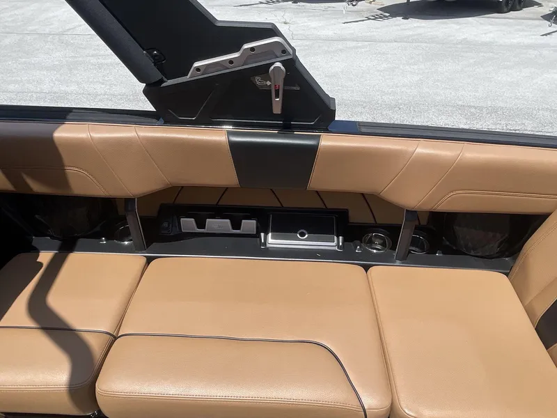 Slide: The Image of 2022 Malibu Wakesetter 23 LSV interior with tan leather seating and storage compartments. - 21
